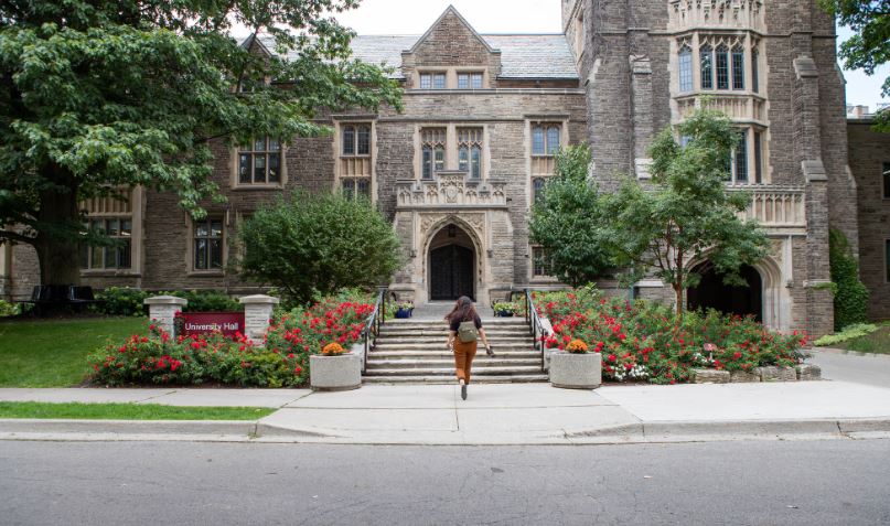 Student walks the steps up to University Hall