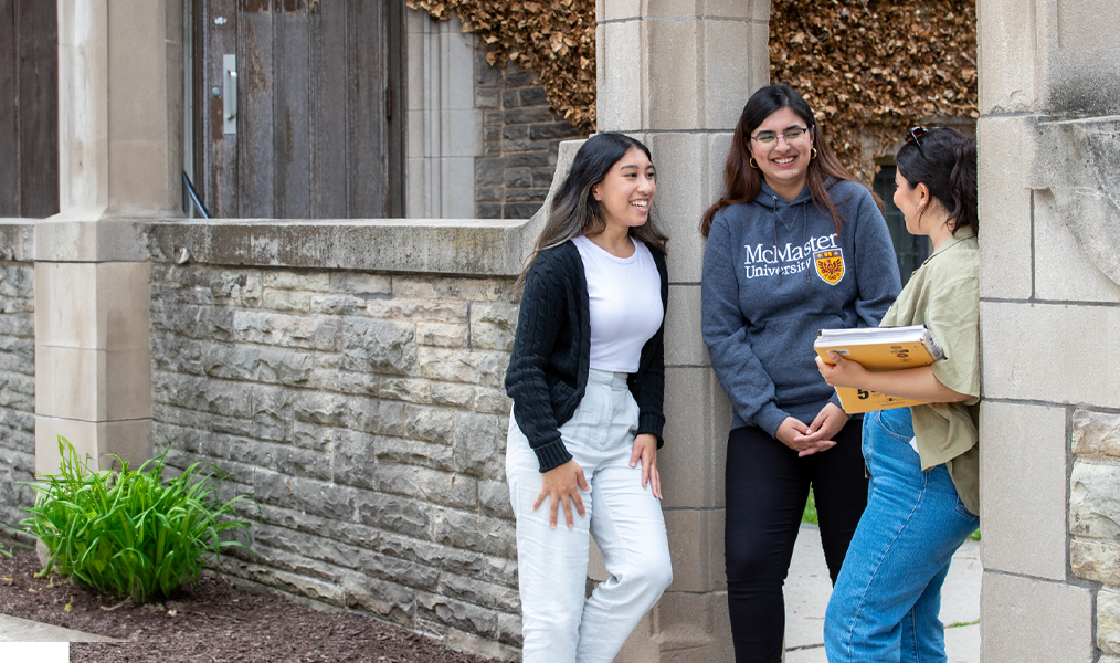 Three students stand by Edward's Arch